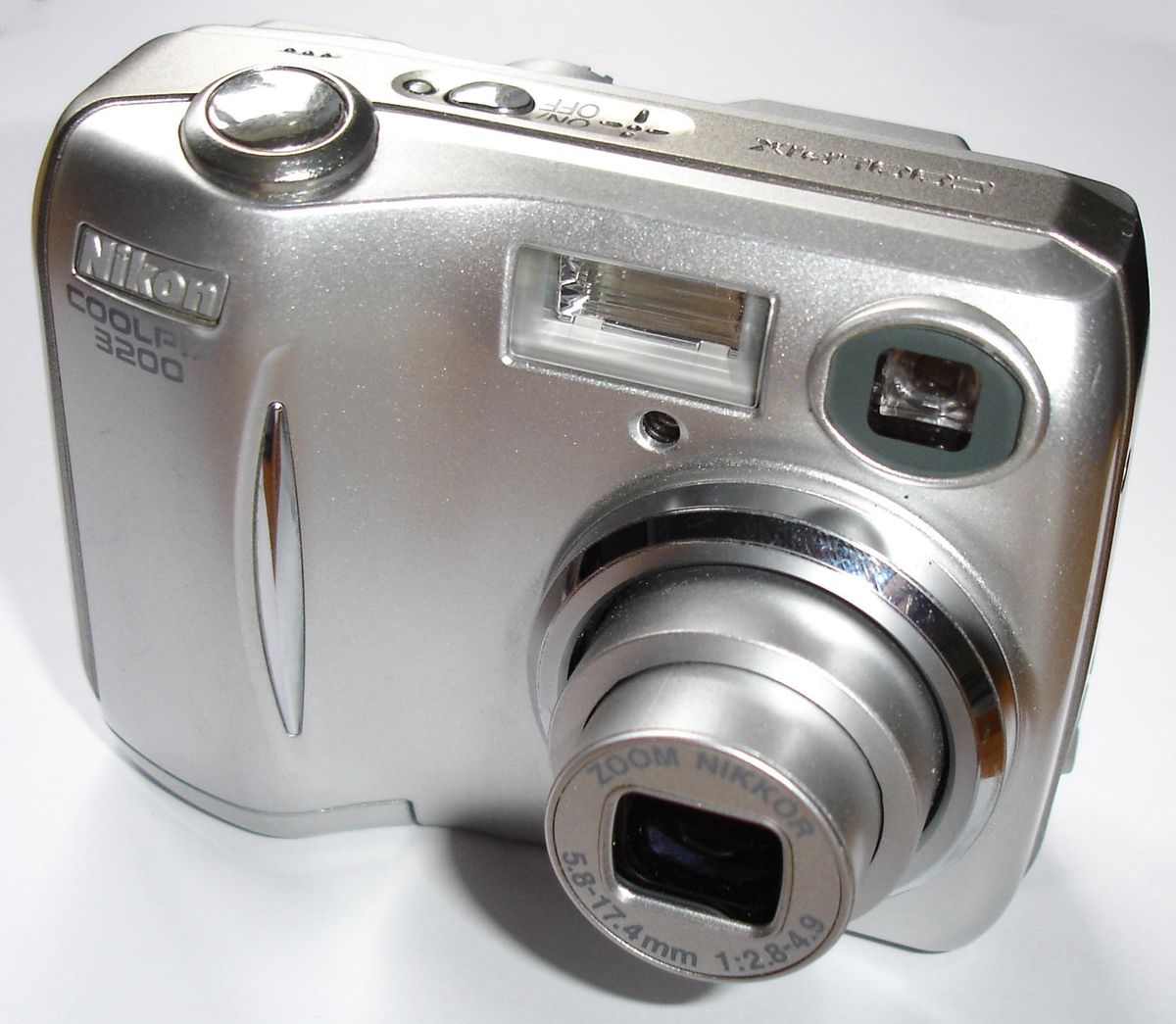 Silver Nikon COOLPIX 3200 compact camera in a close front three-quarter view.